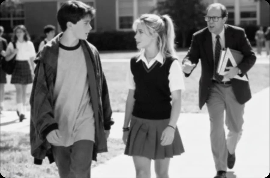 Black-and-white photo of two students and a teacher colourised (Before)